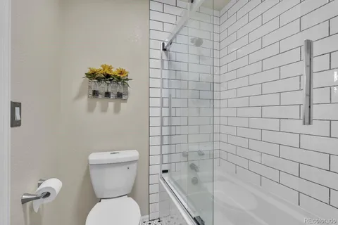 a bathroom with a toilet and a shower