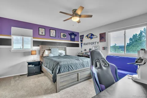 a bedroom with a bed and a large window