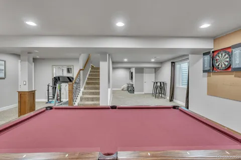 a living room with furniture and stairs