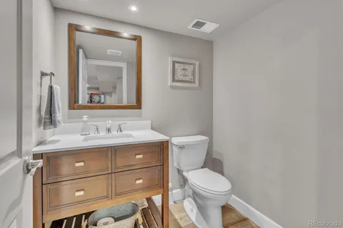 a bathroom with a toilet a sink and mirror