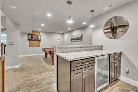 a kitchen with a stove a refrigerator and a chandelier