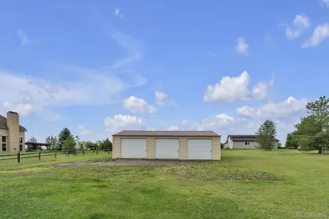 a view of a big yard with a house in the background