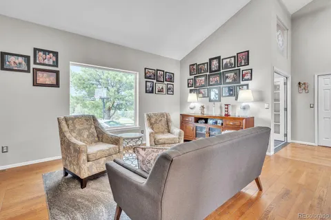 a living room with furniture and a book shelf