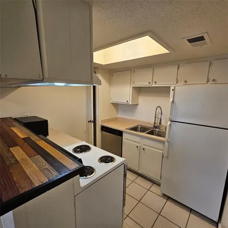 a stove top oven sitting inside of a kitchen