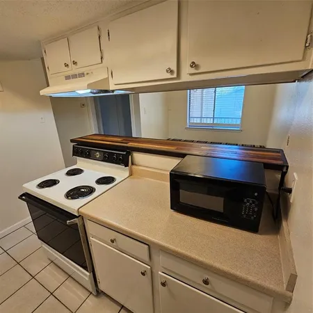 a utility room with cabinets and washer