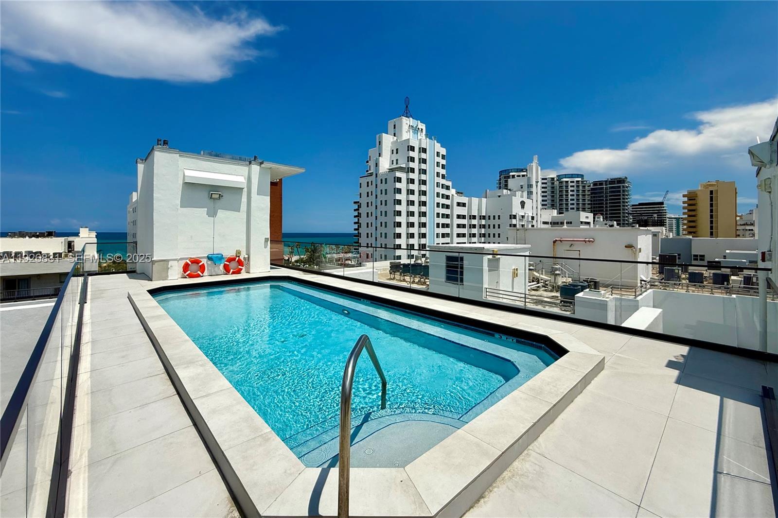 4122 Collins Avenue, Unit 2B Miami Beach, FL 33140 - Photo 13 of 13 a kitchen with a sink dishwasher and a stove with wooden floor