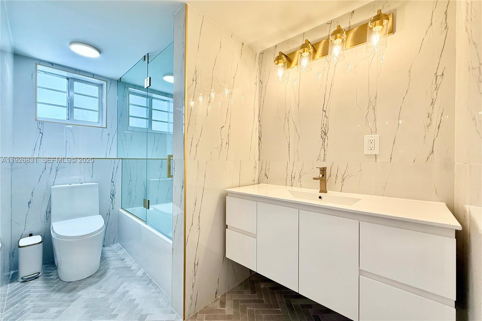 4122 Collins Avenue, Unit 2B Miami Beach, FL 33140 - Photo 7 of 13 a bathroom with a sink and a mirror