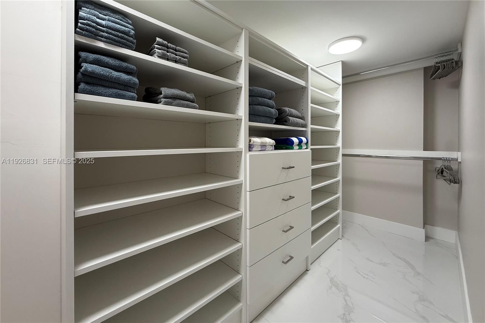 4122 Collins Avenue, Unit 2B Miami Beach, FL 33140 - Photo 8 of 13 a view of walk in closet with empty racks