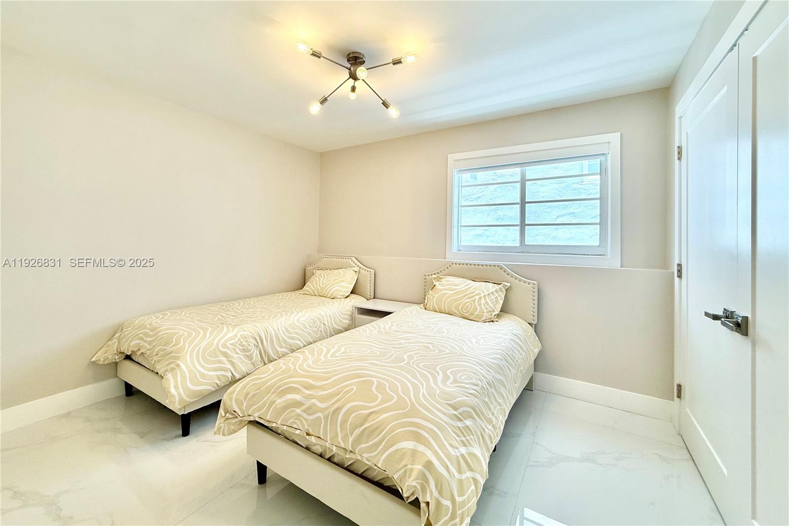 4122 Collins Avenue, Unit 2B Miami Beach, FL 33140 - Photo 9 of 13 a bedroom with two beds and ceiling fan