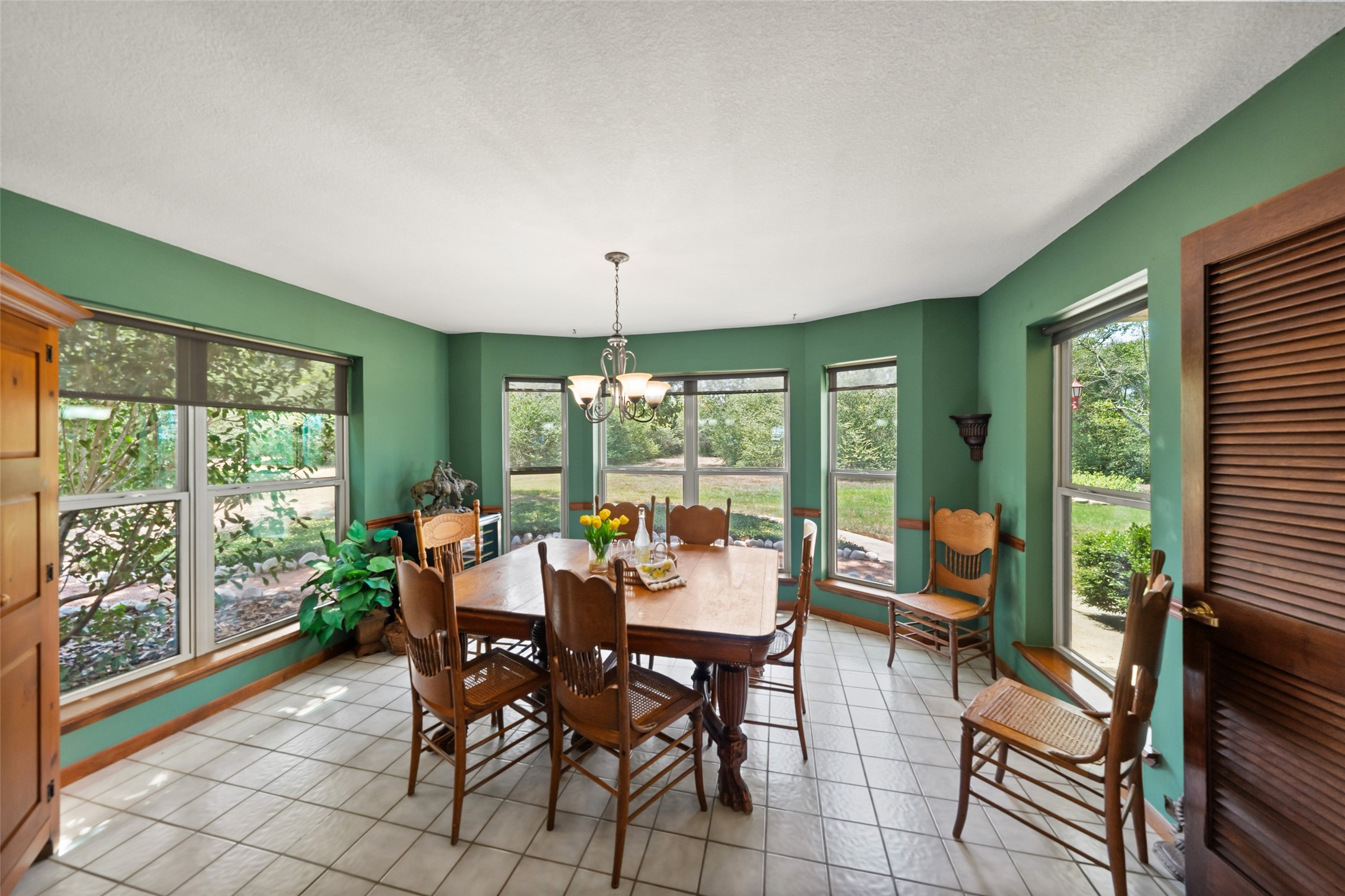 25948 Nelson Road Hempstead, TX 77445 - Photo 14 of 46 Spacious breakfast room featuring abundant natural light, hardwood flooring, and expansive windows overlooking the property.