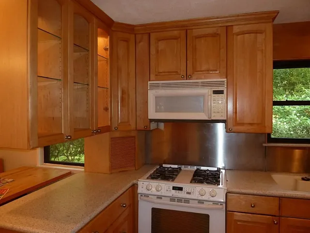 a kitchen with appliances and cabinets