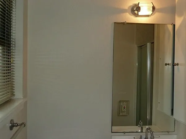 a bathroom with a mirror and a shower