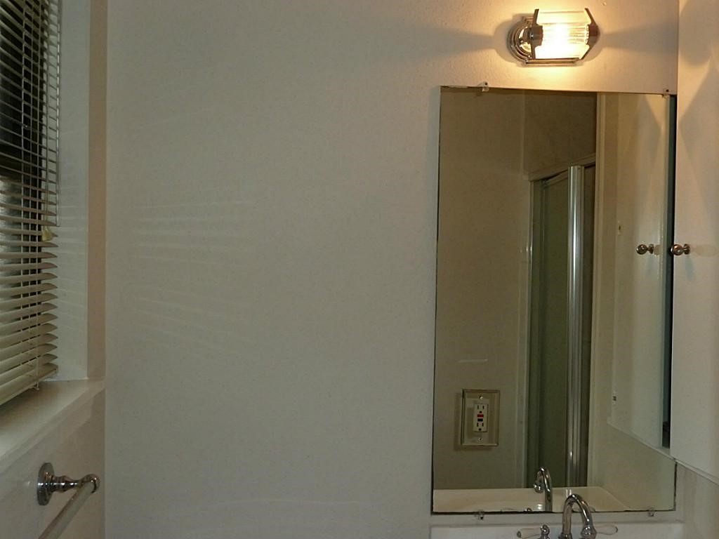 9122 Western Drive Houston, TX 77080 - Photo 15 of 20 a bathroom with a mirror and a shower