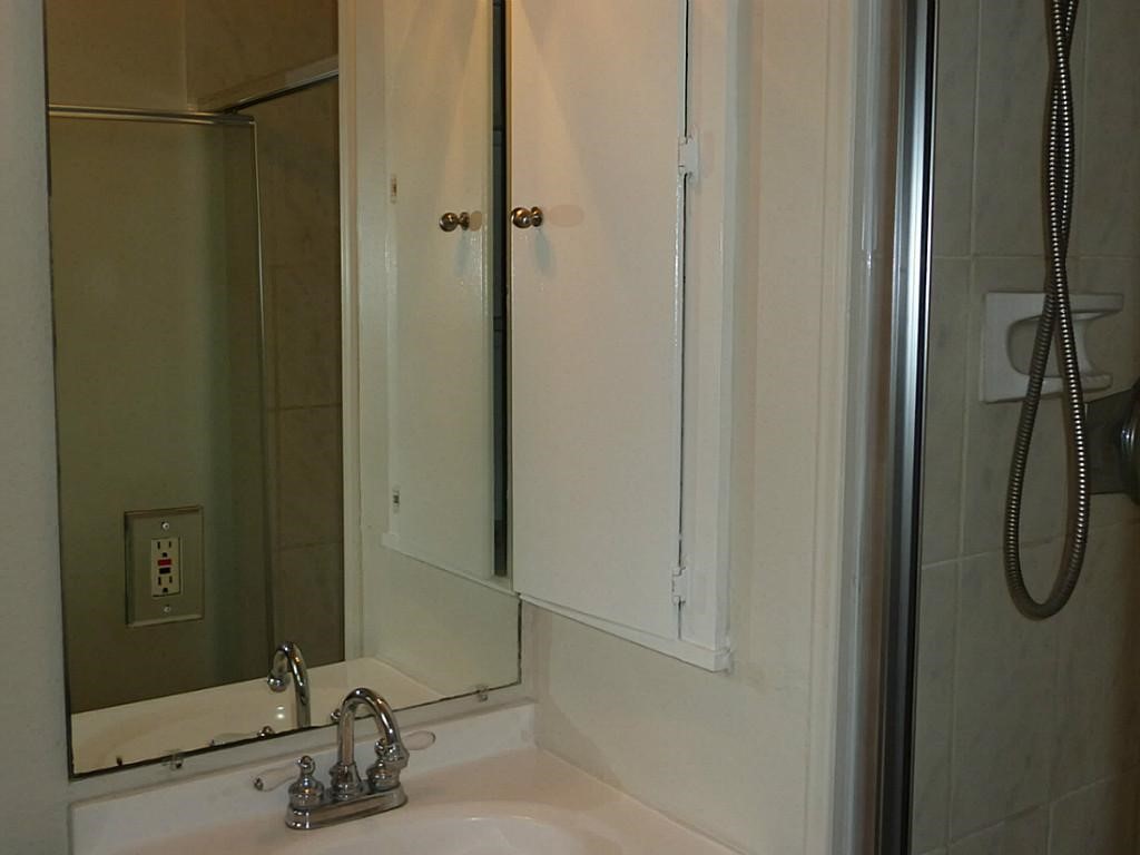 9122 Western Drive Houston, TX 77080 - Photo 16 of 20 a bathroom with a sink and a mirror