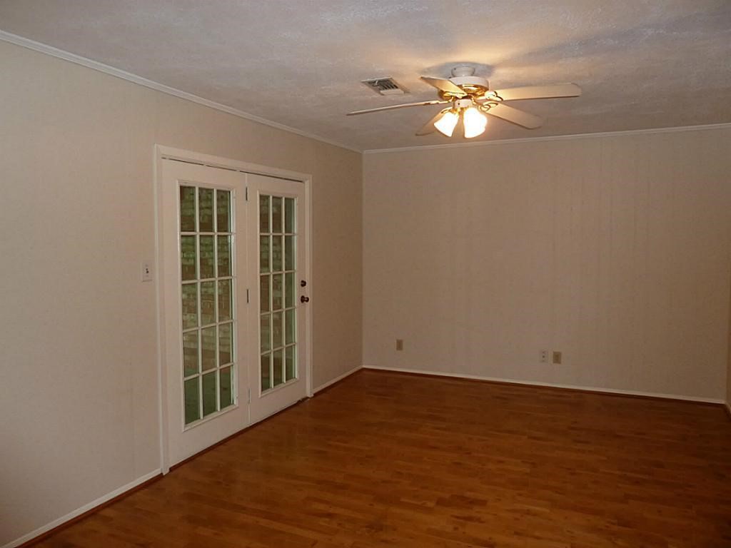 9122 Western Drive Houston, TX 77080 - Photo 4 of 20 a view of wooden floor and a chandelier fan in a room