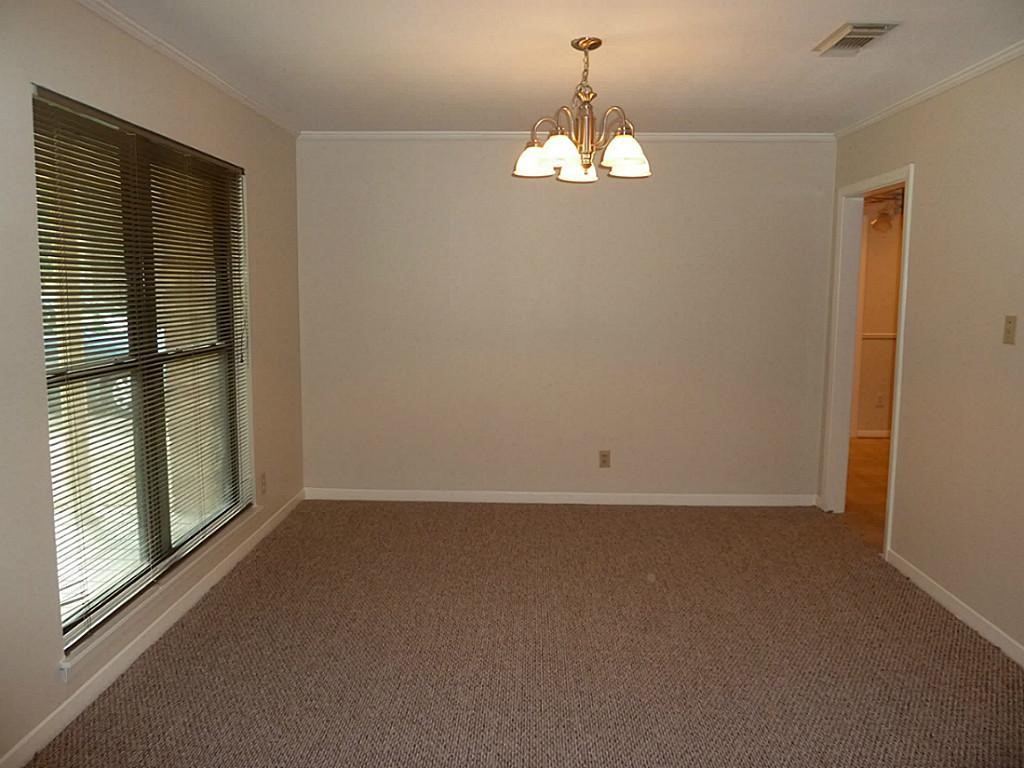 9122 Western Drive Houston, TX 77080 - Photo 5 of 20 en empty room with windows and chandelier