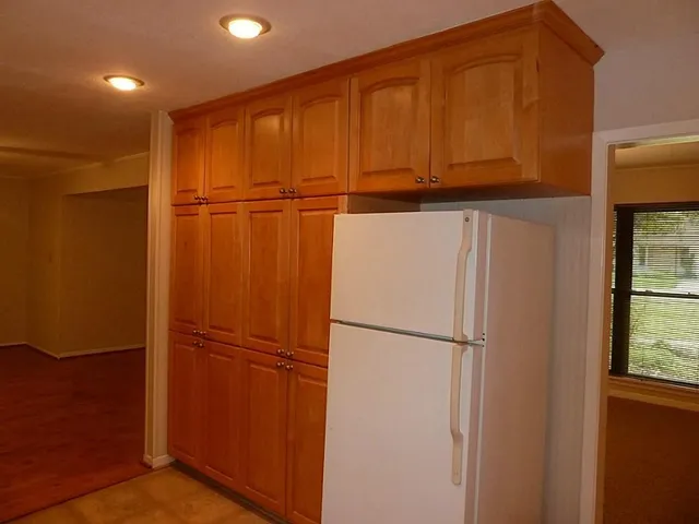 a empty room with wooden floor and a window