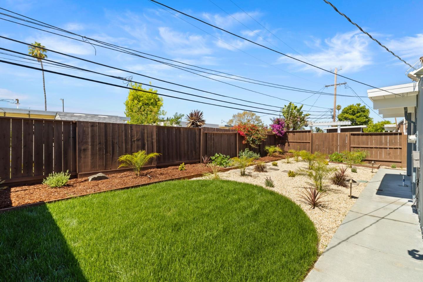 1734 Wolfe Drive San Mateo, CA 94402 - Photo 35 of 43 a view of a backyard with a patio and a garden