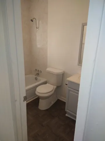 a white toilet sitting next to a sink