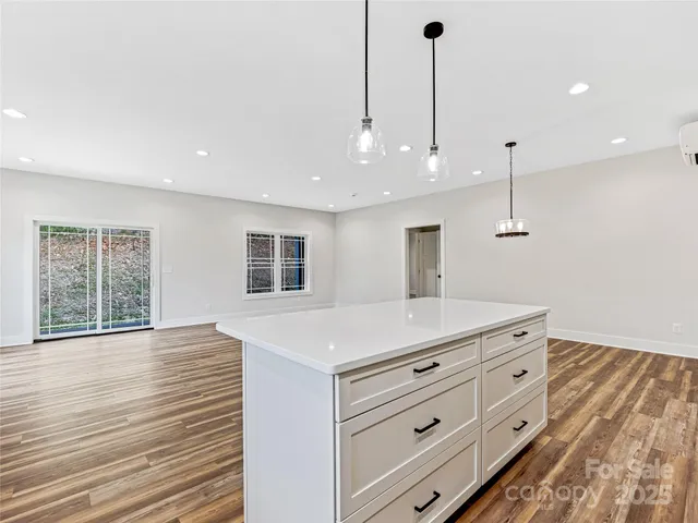 a room with a center island and a window