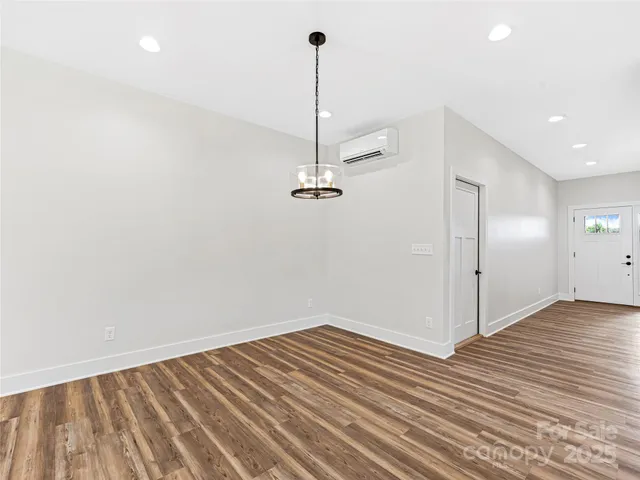 a view of a room with wooden floor