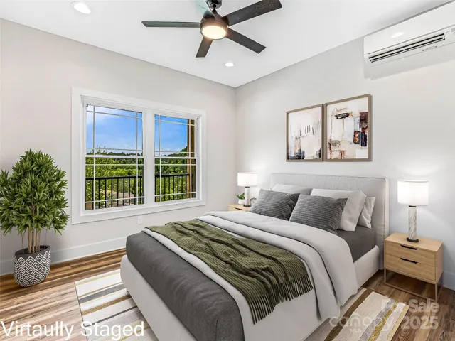 a bedroom with a large bed and a potted plant