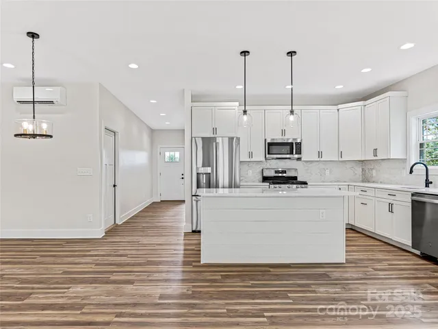 a large kitchen with stainless steel appliances