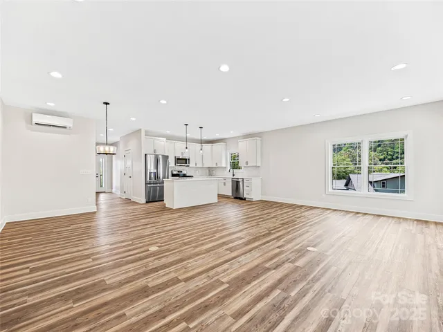 a view of kitchen with furniture and wooden floor