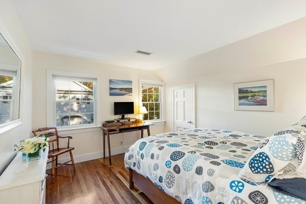 34 Earle Road Wellesley, MA 02481 - Photo 20 of 28 a bedroom with a bed and a table in it with window