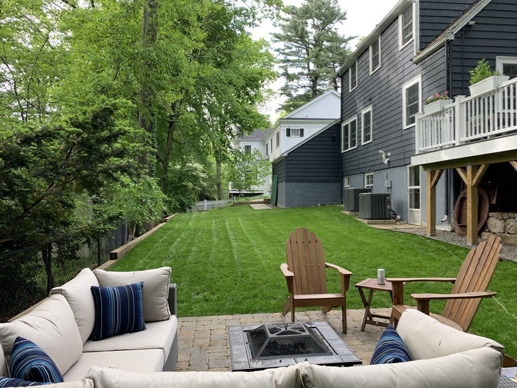 34 Earle Road Wellesley, MA 02481 - Photo 25 of 28 a view of backyard with seating area and green space