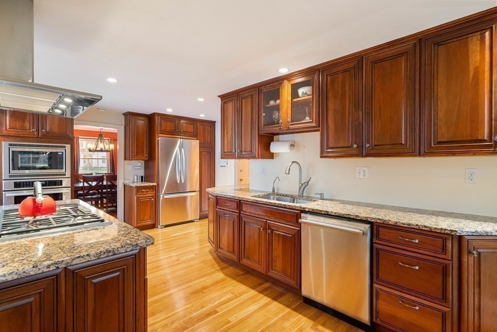 34 Earle Road Wellesley, MA 02481 - Photo 10 of 28 a kitchen with stainless steel appliances granite countertop a sink dishwasher stove and refrigerator with wooden cabinets