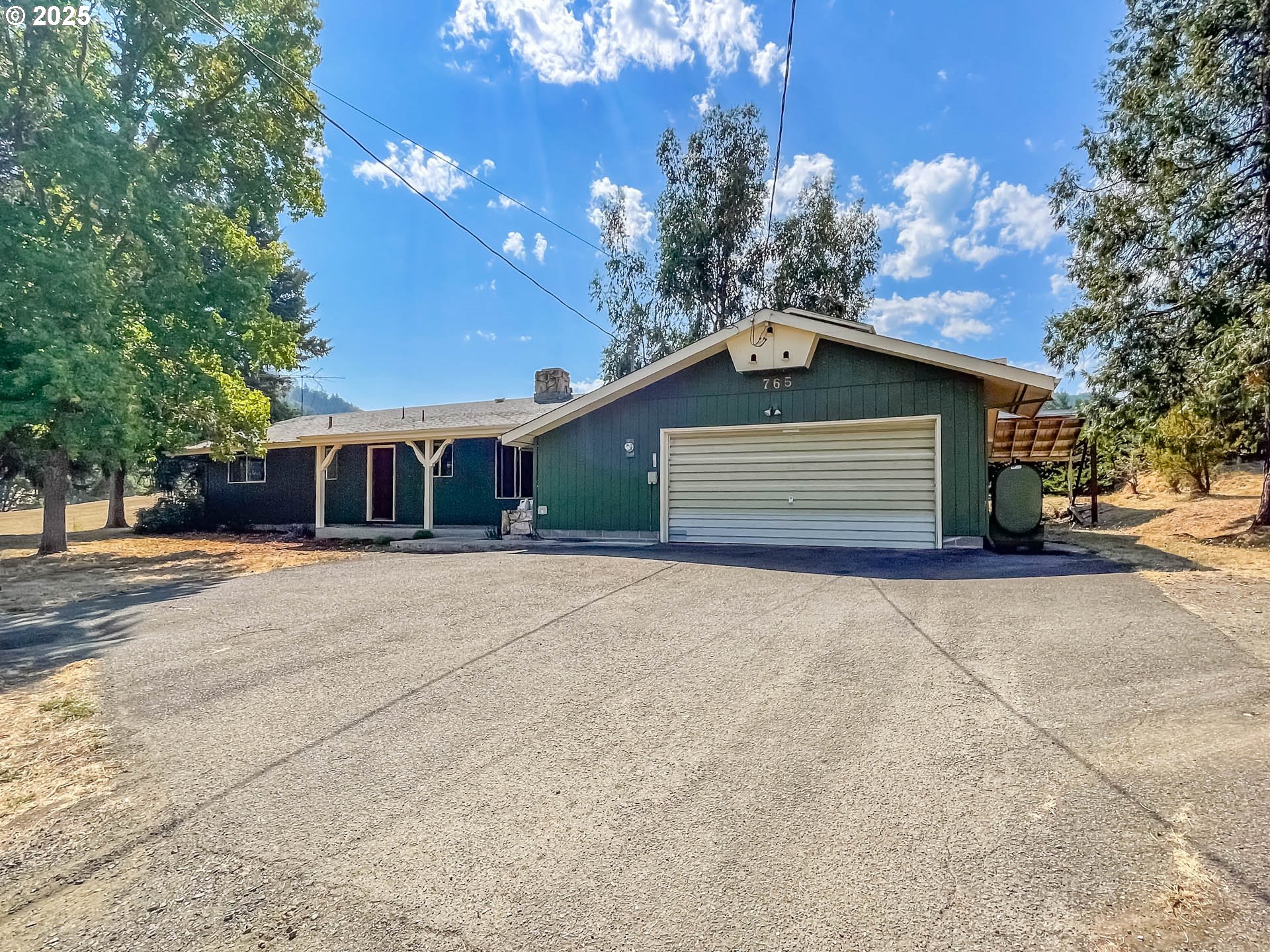 765 O C Brown Road Roseburg, OR 97470 - Photo 1 of 48 a front view of a house with a yard and garage