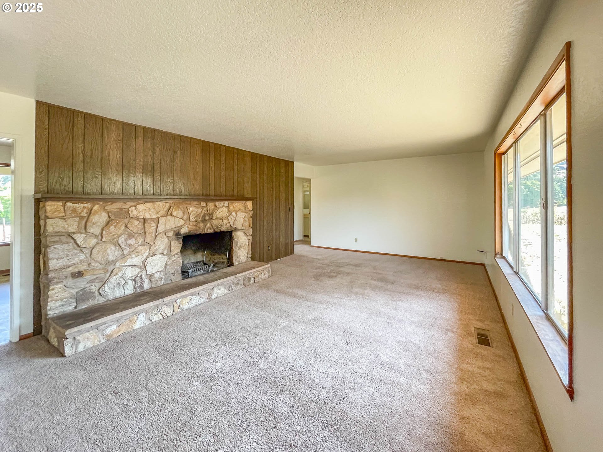 765 O C Brown Road Roseburg, OR 97470 - Photo 11 of 48 an empty room with fireplace and windows
