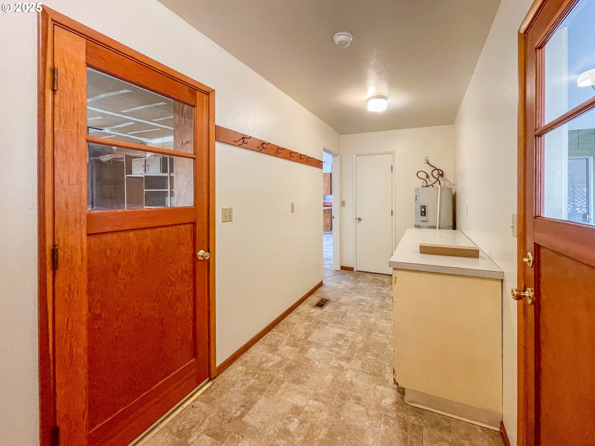 765 O C Brown Road Roseburg, OR 97470 - Photo 27 of 48 a hallway with a refrigerator and a stove