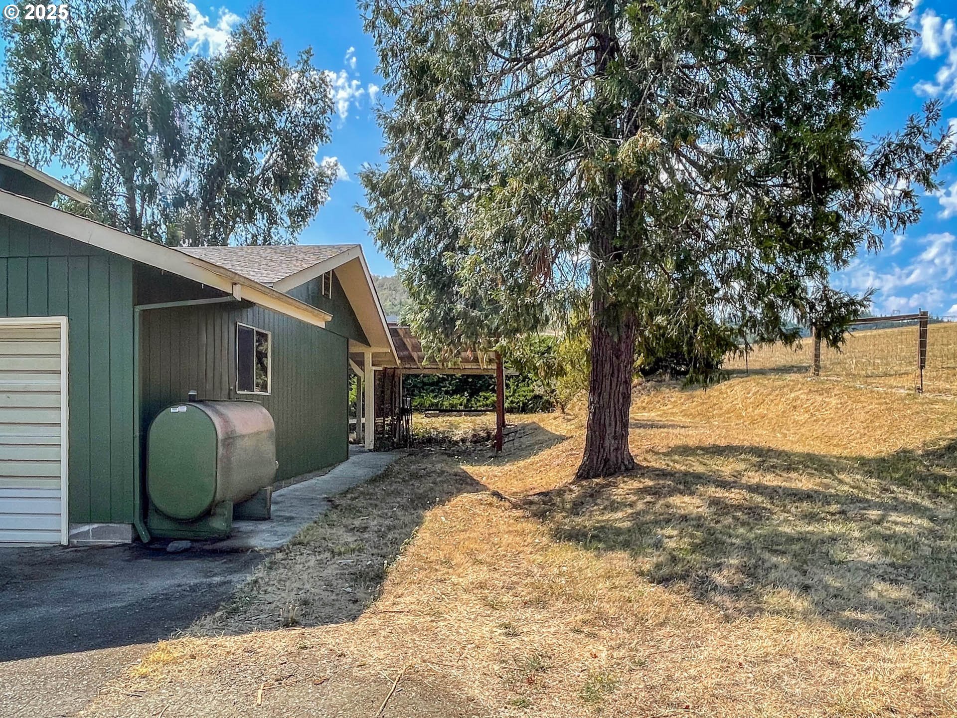 765 O C Brown Road Roseburg, OR 97470 - Photo 31 of 48 a backyard of a house with yard and wooden fence