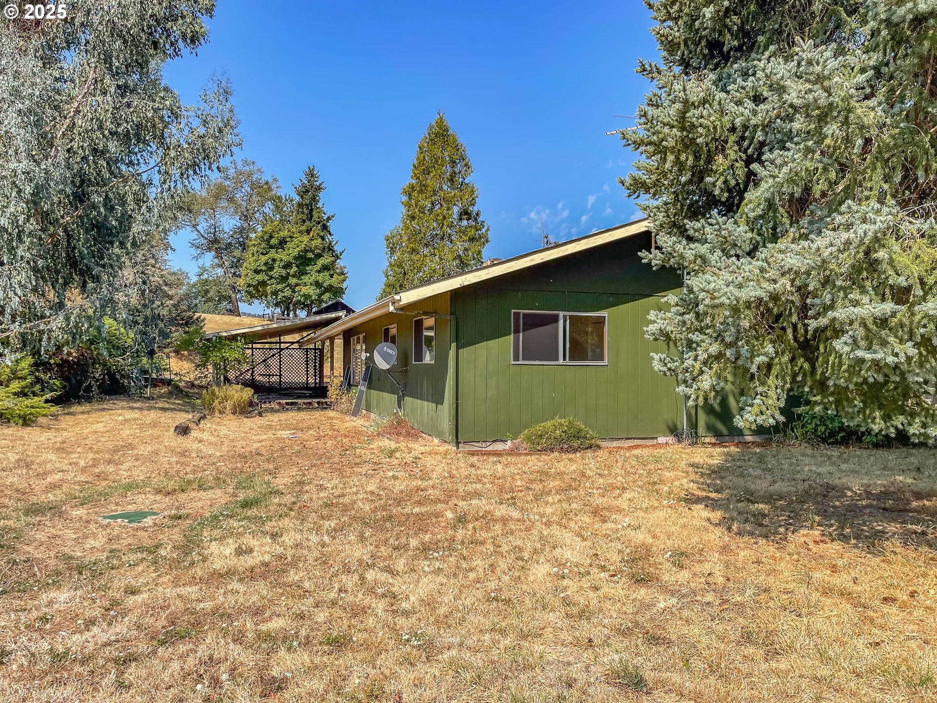 765 O C Brown Road Roseburg, OR 97470 - Photo 36 of 48 a backyard of a house with large trees