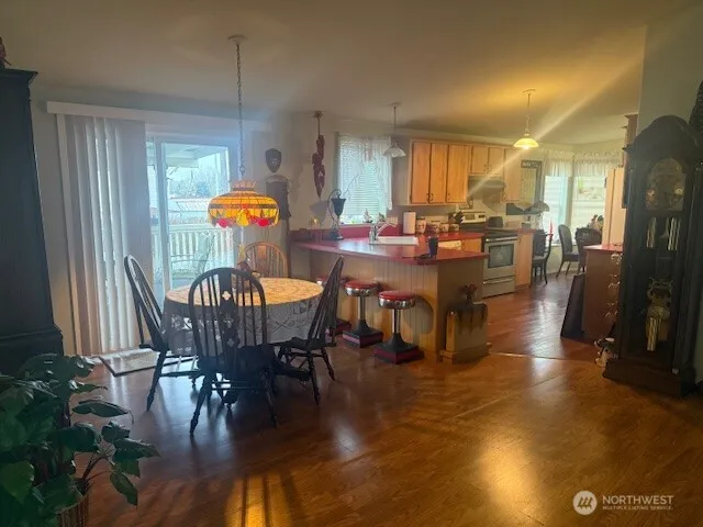 a view of a dining room with furniture window and wooden floor