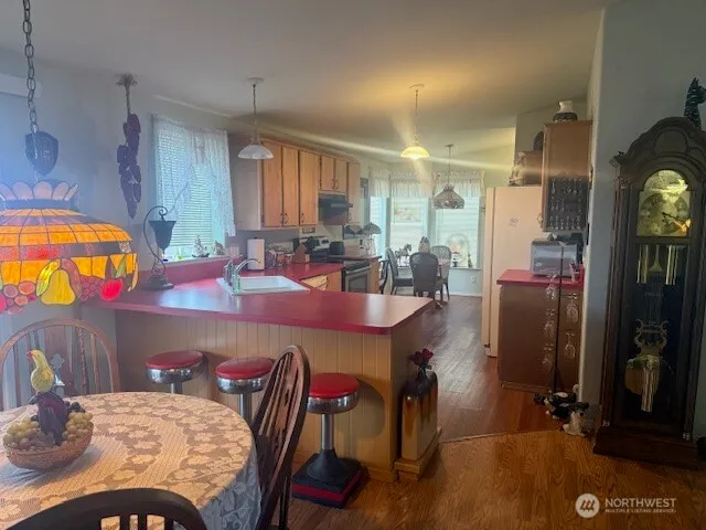 a view of a dining room with furniture and a chandelier