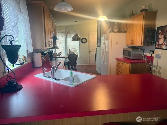 a kitchen with furniture a refrigerator and a sink