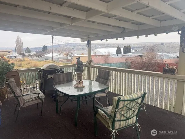 a view of a porch with furniture and a yard