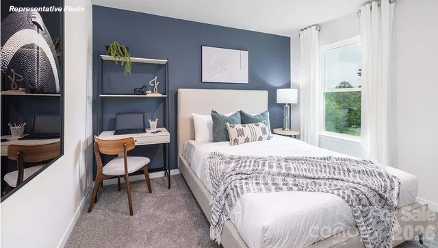 a bedroom with a bed a table and chair