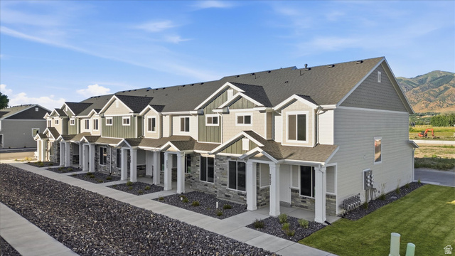 2257 South 1090 West, Unit 74 Nibley, UT 84321 - Photo 31 of 40 Modern townhome exteriors featuring horizontal siding, vertical siding accents, and stone veneer detailing