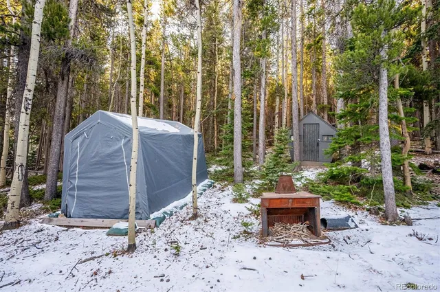a view of a bench in the backyard of the house
