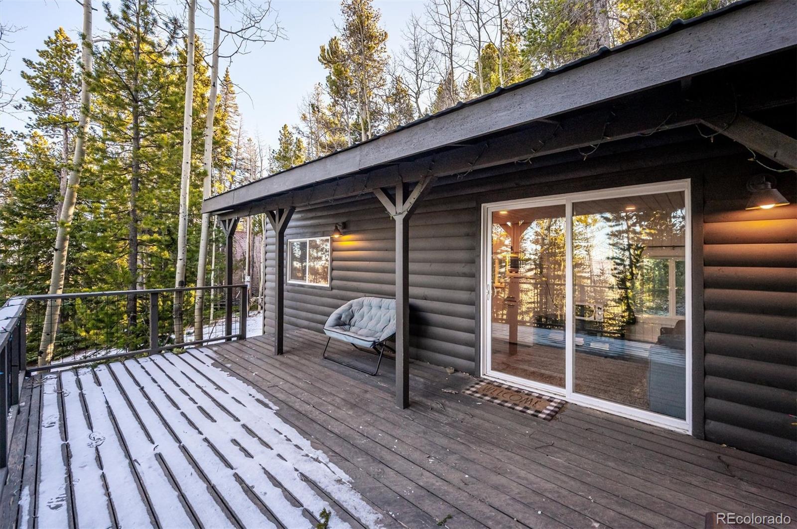 2334 Sinton Road Evergreen, CO 80439 - Photo 18 of 28 a view of deck with wooden floor and outdoor seating