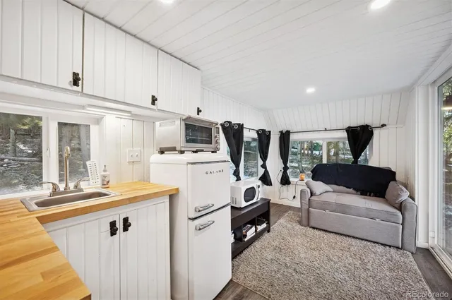 a living room with furniture and kitchen view