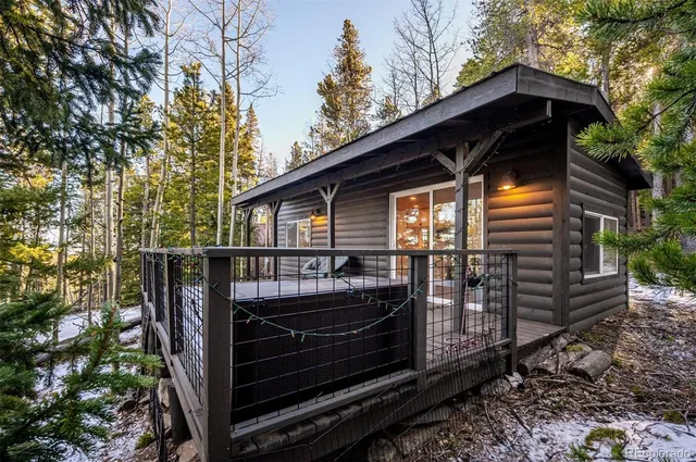 a front view of a house with balcony and wooden fence