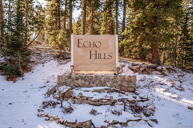 a sign that is sitting in the middle of the forest