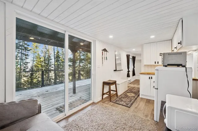 a living room with furniture a rug and a large window