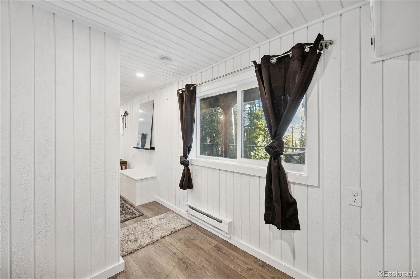 2334 Sinton Road Evergreen, CO 80439 - Photo 8 of 28 a view of a hallway with wooden floor and entryway