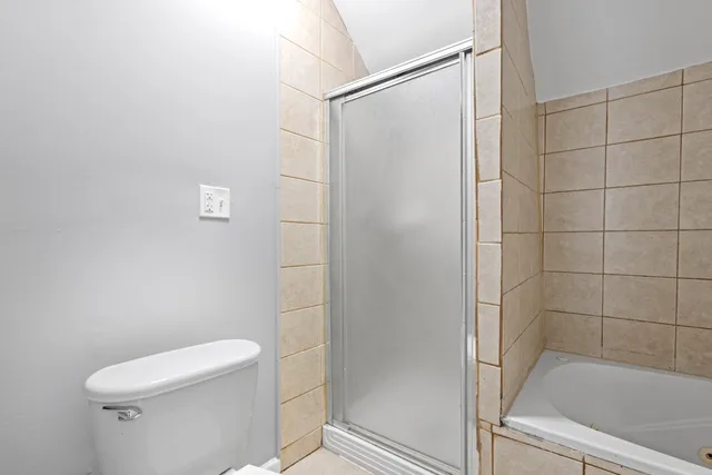 a bathroom with a shower and a toilet